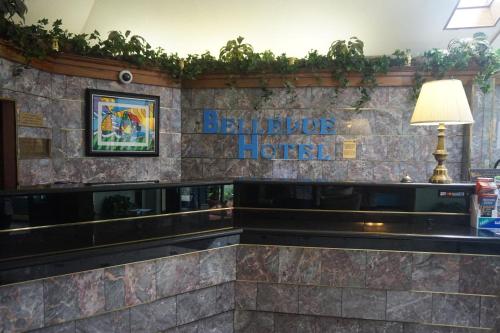 a bar in a hotel with a sign on the wall at Bellevue Hotel and Suites in Bellevue