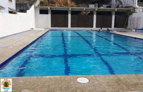 a large swimming pool with blue water at Tudor Water Sports Hotel in Mombasa