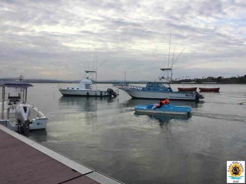 a group of boats are docked in the water at Tudor Water Sports Hotel in Mombasa