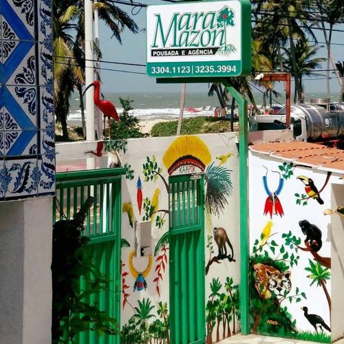 a wall with a mural of birds on it at Pousada Maramazon in São Luís