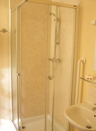 a shower with a glass door in a bathroom at The Kings Head Hotel in Abergavenny