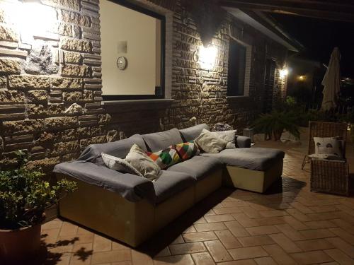 a couch with pillows on it in a patio at Villa Isotta in Trevignano Romano