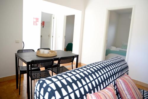 a living room with a table and chairs and a couch at Porto Smart Apartments- airport in Perafita