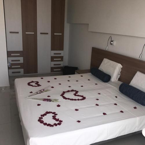 a bedroom with a bed with red flowers on it at Escape to St Julians in St Julian's