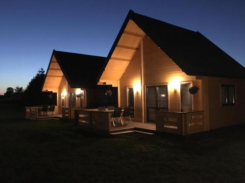 a small house with lights on the side of it at Łebskie Chatki in Łeba