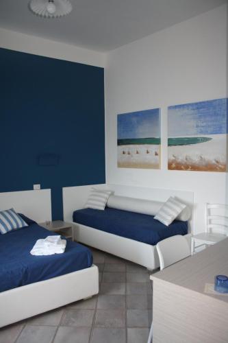 two beds in a room with blue and white at Da Nino sul mare Filicudi in Filicudi