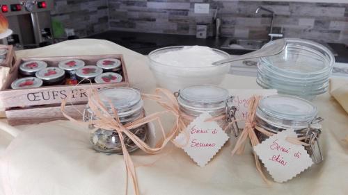 a table with jars of cupcakes and a box of sweets at B&B CasalFarano in Cupra Marittima