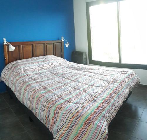 Una cama o camas en una habitación de Departamentos Esperanza