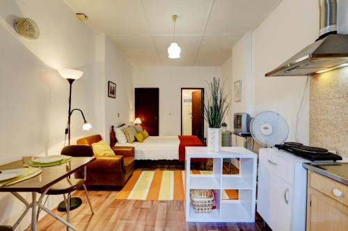 a kitchen and living room with a couch and a bed at Mértola low-cost in Mértola