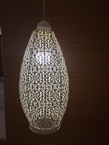 a large silver light bulb hanging from a ceiling at Nava Grand in Ban Talat Rangsit