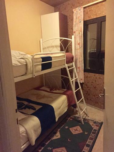 a bunk bed room with two bunk beds in it at Stone Chalets in Fārayyā