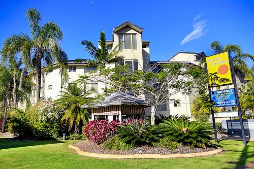 a large white building with a sign in front of it at Sandcastles On Currumbin Beachfront, Gold Coast in Gold Coast