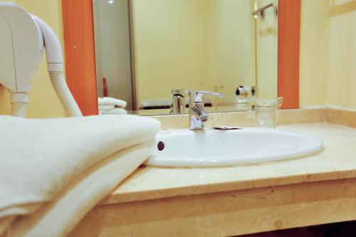 a bathroom counter with a sink and a mirror at Ibis Fes in Fez