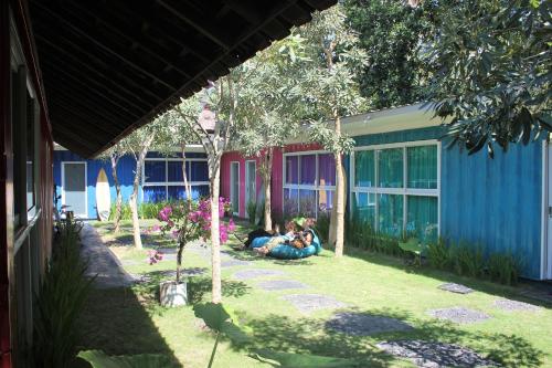a person laying on the grass in front of a house at Kubu Container in Uluwatu