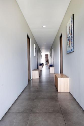 a hallway with white walls and a row of tables at M Pavilion - Lippo Karawaci in Tangerang
