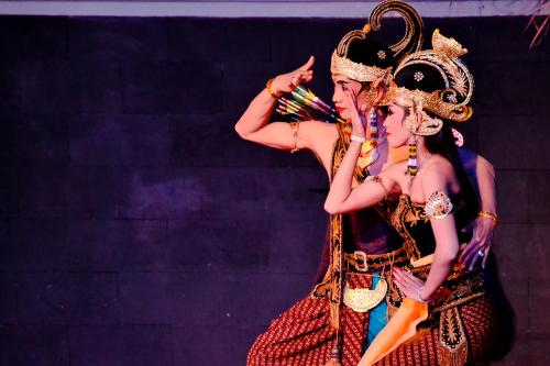 two women dressed in costumes on a stage at Tasneem Hotel Malioboro Yogyakarta in Yogyakarta