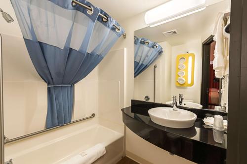 W łazience znajduje się umywalka, wanna i umywalka. w obiekcie Motel 6-Moosomin, SK w mieście Moosomin