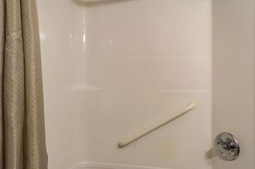 a shower door with a towel rod in a bathroom at Motel 6-Lincoln City, OR in Lincoln City