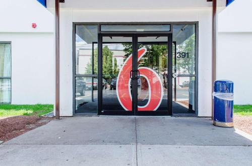 a door to a store with a sign in it at Motel 6-Brockton, MA in Brockton
