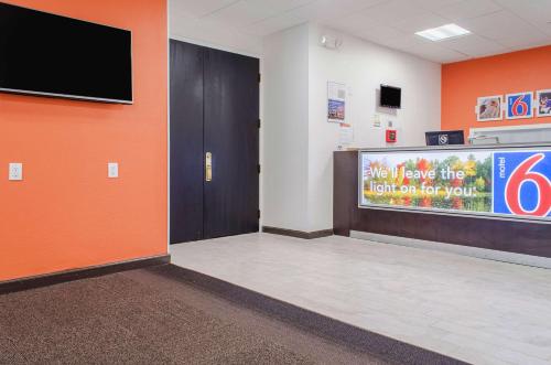a waiting room with a tv on a wall at Motel 6-Brockton, MA in Brockton