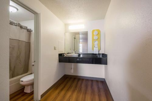 a bathroom with a sink and a toilet and a mirror at Motel 6-Indianapolis, IN - South in Indianapolis