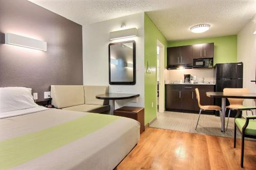 a hotel room with a bed and a kitchen at Studio 6-Austin, TX - Northwest in Austin