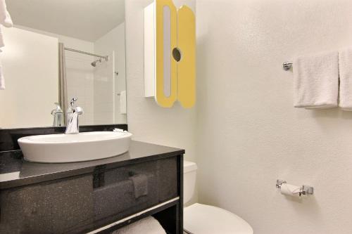 a white bathroom with a sink and a toilet at Studio 6-Austin, TX - Northwest in Austin