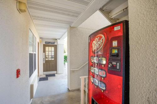 a cocacola machine in a hallway of a building at Studio 6-Stafford, TX - Houston - Sugarland in Stafford