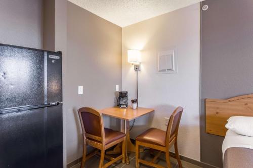 a small room with a small table and chairs at Studio 6-Albuquerque, NM - North in Albuquerque