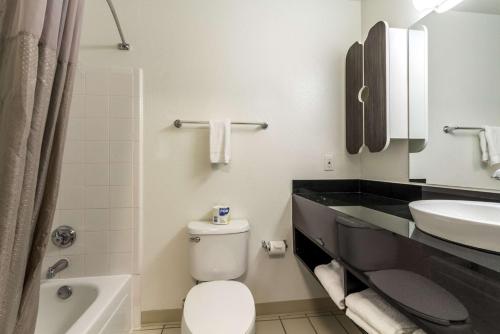 a bathroom with a toilet and a sink at Studio 6-Dallas, TX - Northwest in Dallas