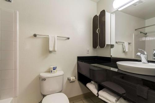a bathroom with a toilet and a sink at Studio 6-Dallas, TX - Northwest in Dallas