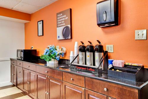 a counter in a room with an orange wall at Motel 6-Washington, DC in Washington, D.C.