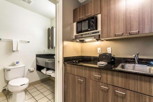 a small bathroom with a toilet and a sink at Studio 6-Dallas, TX - Northwest in Dallas