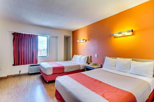 a hotel room with two beds and a window at Motel 6-Washington, DC in Washington, D.C.