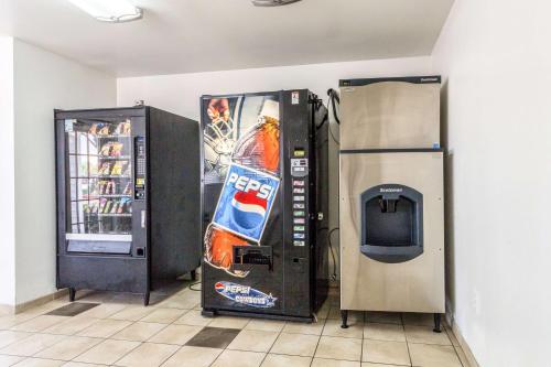 a vending machine with a bottle of coke and a refrigerator at Studio 6-Dallas, TX - Northwest in Dallas