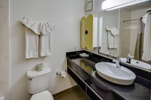 a bathroom with a white toilet and a sink at Studio 6-Houston, TX - Hobby South in Houston