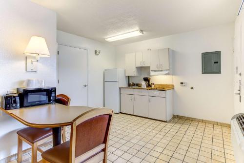 a kitchen and dining room with a table and chairs at Studio 6-Kissimmee, FL - Orlando in Orlando