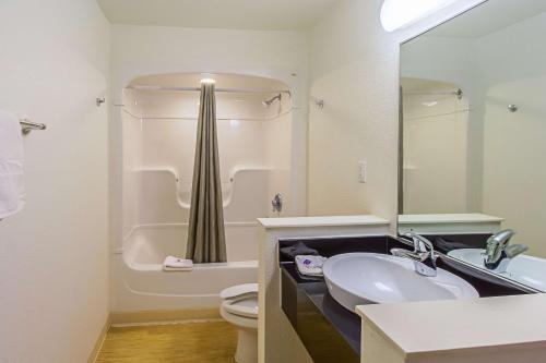 a bathroom with a sink and a toilet and a mirror at Ocean Inn South Padre Island in South Padre Island