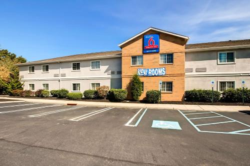 a building with a no parking lot in front of it at Studio 6-East Brunswick, NJ - NYC Area in East Brunswick
