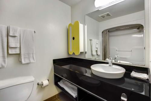 a bathroom with a sink and a toilet and a mirror at Studio 6-East Brunswick, NJ - NYC Area in East Brunswick