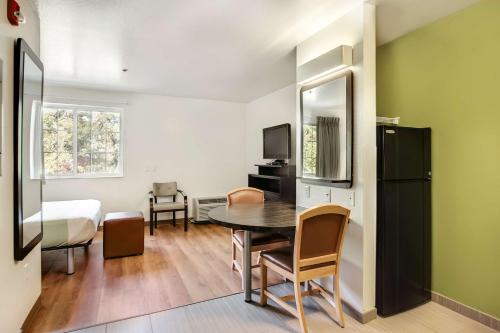 a small room with a table and a bedroom at Studio 6-East Brunswick, NJ - NYC Area in East Brunswick