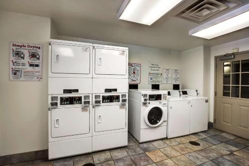 a laundry room with white appliances and a washer and dryer at Studio 6-East Brunswick, NJ - NYC Area in East Brunswick