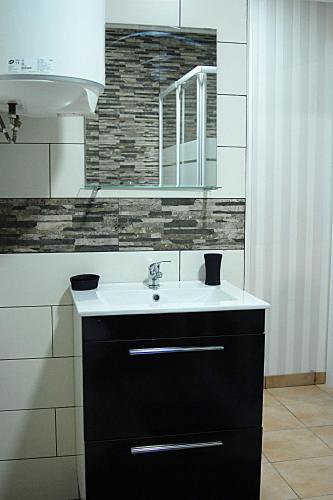 a bathroom with a sink and a mirror at Casa Faroleiro in Nazaré