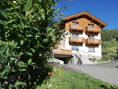 a building with balconies on the side of it at Hotel Le Alpi in Livigno