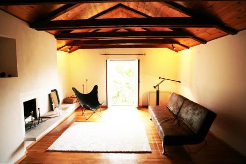 a living room with a leather couch and a fireplace at Cozy apartment in the green in Locarno