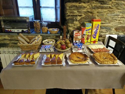 a table with a buffet of food on it at Finca O Bizarro in Trabada