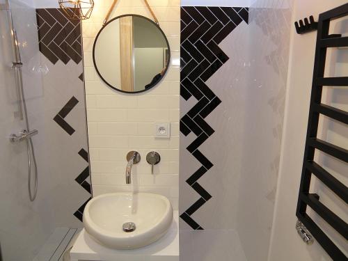 a bathroom with a sink and a mirror at Aloza in Ustka