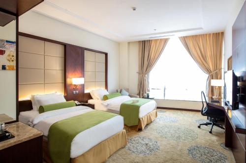Giường trong phòng chung tại Prime Al Hamra Hotel