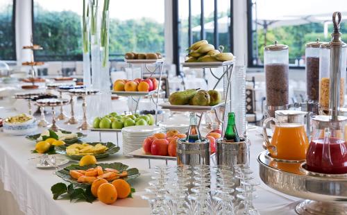a table with many plates of fruits and other food at La Medusa Hotel - Dimora di Charme in Castellammare di Stabia