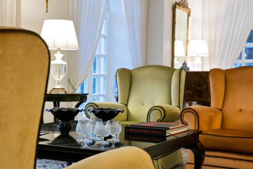 a living room with two chairs and a table at La Medusa Hotel - Dimora di Charme in Castellammare di Stabia